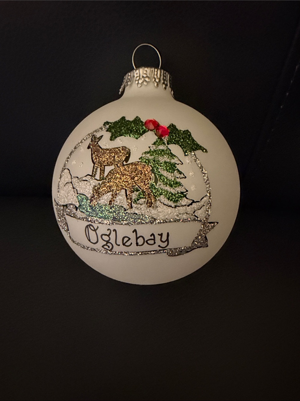 Teresa Thibault “Oglebay” White Glass Ornament with Gold Deer and Green Holly